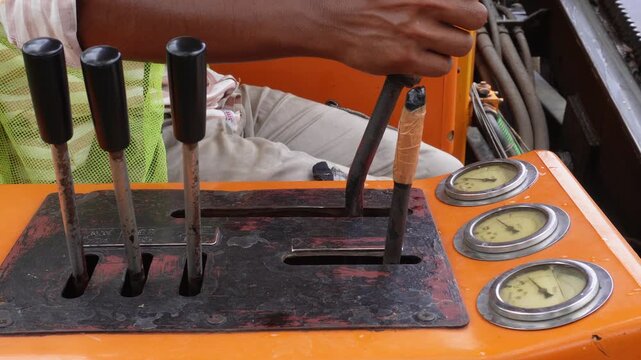 Crane driver operating hydraulic control levers