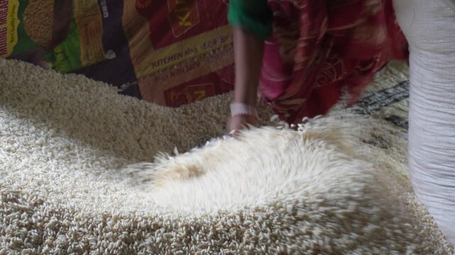 Worker handling fresh puffed rice with care