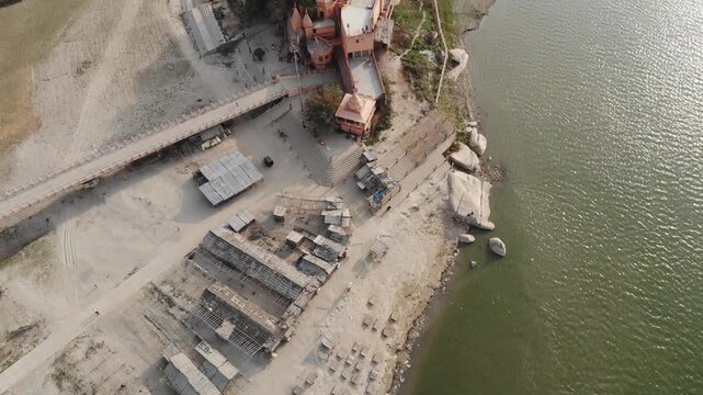 Aerial drone footage of Sultanganj, Bihar, featuring the sacred Ganges River, Ajgaibinath Temple, pilgrims, boats, and the spiritual starting point of the Kanwar Yatra during Shravan.