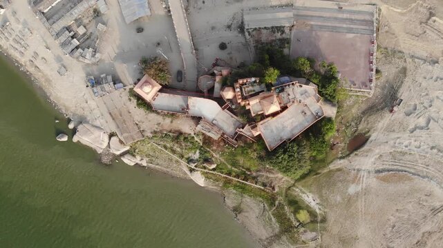 Aerial drone footage of Sultanganj, Bihar, featuring the sacred Ganges River, Ajgaibinath Temple, pilgrims, boats, and the spiritual starting point of the Kanwar Yatra during Shravan.