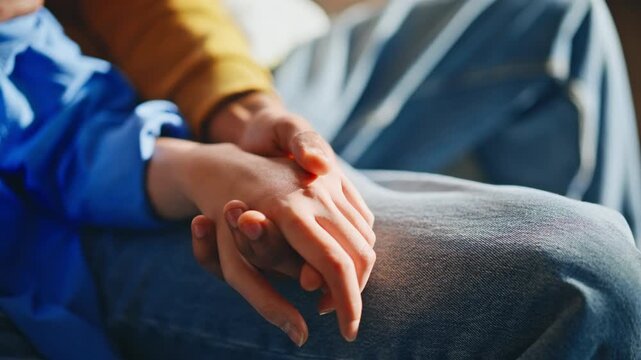 Close up couple holding hands together home. Tender touch supportive partners.