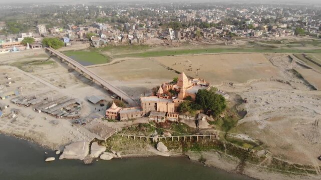 Aerial drone footage of Sultanganj, Bihar, featuring the sacred Ganges River, Ajgaibinath Temple, pilgrims, boats, and the spiritual starting point of the Kanwar Yatra during Shravan.