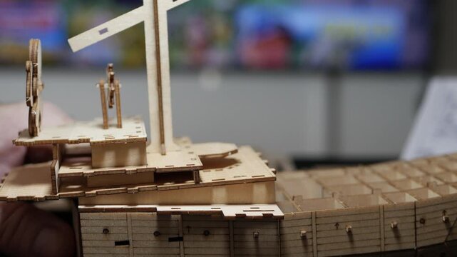 Detailed Wooden 3D Puzzle Ship Construction Closeup. Creative DIY Wooden Steampunk Ship Model Building