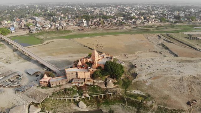 Aerial drone footage of Sultanganj, Bihar, featuring the sacred Ganges River, Ajgaibinath Temple, pilgrims, boats, and the spiritual starting point of the Kanwar Yatra during Shravan.