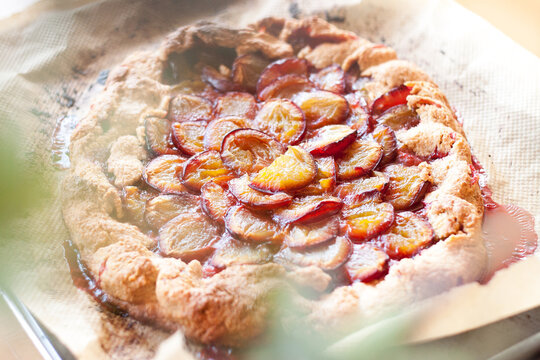 Rustic homemade plum or damson galette fresh from the oven