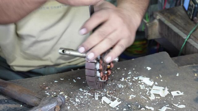 Motor stator coil rewinding with skilled hands