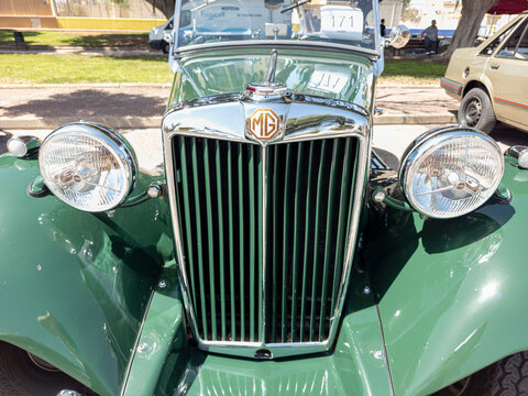 TAVERNES BLANQUES, SPAIN - JUNE 14, 2026.Close up of a green vintage MG TF roadster showing the bumper, headlights, and radiator grille in a sunny location
