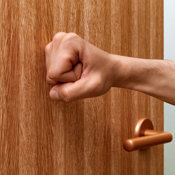 Hand knocking on wooden door with copy space representing opportunity communication and entrance