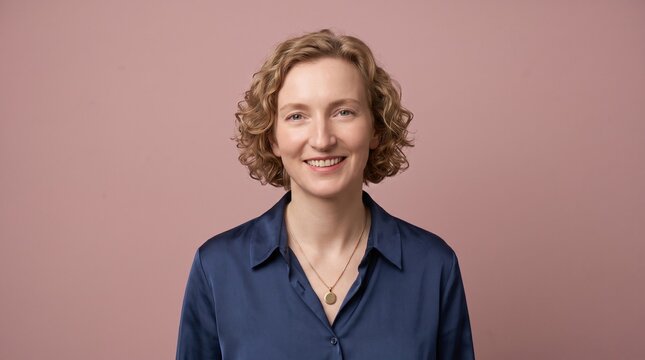 Professional Woman Smiling at Camera Against Pink Background