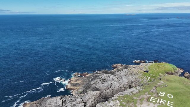 Aerial view of the &Eacute;IRE 80 marker at Malin Head Donegal Ireland in summer 4K