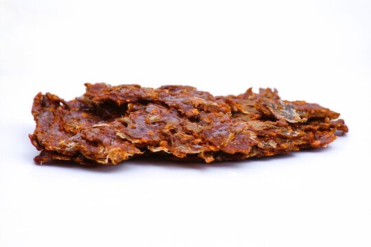 Image of spicy beef jerky on white background.