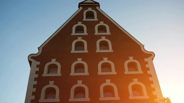 Sun shines through the windows of a tall building.   Torun is city on Vistula River in north-central Poland and UNESCO World Heritage Site.