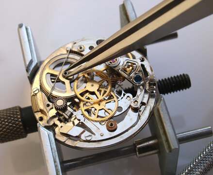 Macro photography concept of internal mechanism and vintage gears of a mechanical watch under repair