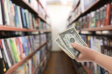 Little child with pocket money in bookstore, closeup © New Africa
