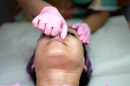 Woman receiving buccal facial massage for rejuvenation