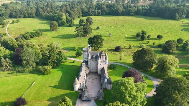 Establishing drone shot of Castle Fraser, Garden & Estate in the countryside of Aberdeenshire, Scotland, United Kingdom	