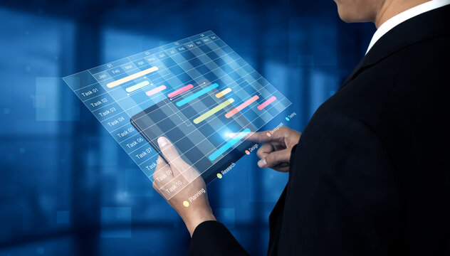 A business professional interacts with a transparent touchscreen displaying graphs and charts for data analysis and project management in a modern workspace. Cyphers