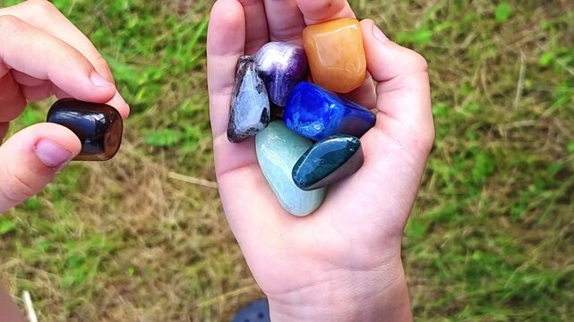 Natural minerals in hand. Semi-precious multi-colored stones, minerals close-up. Mineralogy. Collection of minerals.