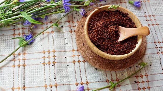 Ground chicory root, chicory flowers and chicory drink on a rustic wooden background. Alternative medicine. Healthy drinks