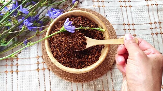 Ground chicory root, chicory flowers and chicory drink on a rustic wooden background. Alternative medicine. Healthy drinks
