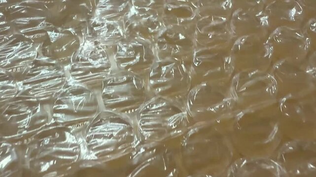 Closeup view of transparent bubble wrap texture with intricate light reflections