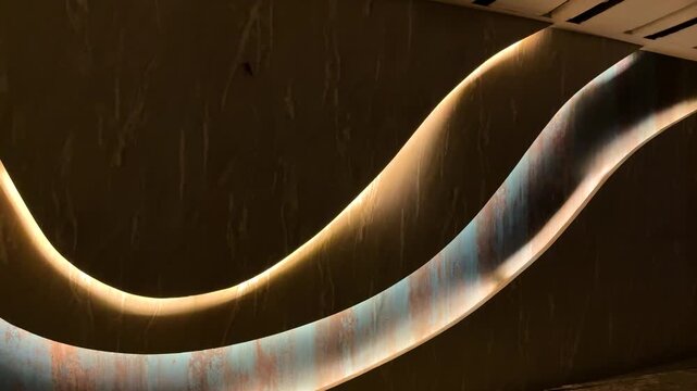 Abstract light and shadow play on textured surface with elegant curves and warm tones