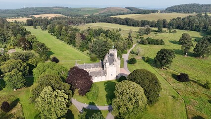 Panoramic drone stock photo of Castle Fraser Garden and Estate showcasing medieval turrets and manicured green grounds in Aberdeenshire, Scotland, United Kingdom © Ramses