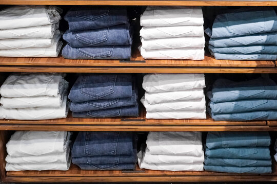 Folded Jeans on Wooden Shelves