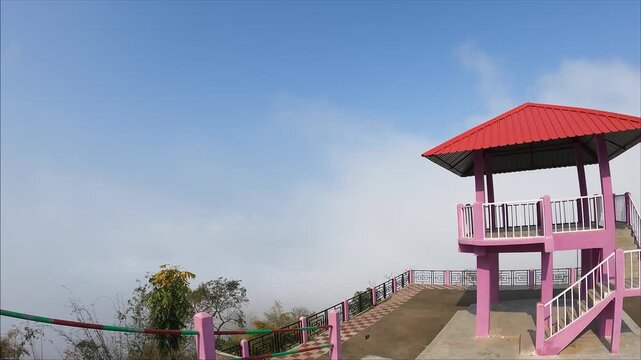 GUNJUNG, ASSAM, INDIA - MARCH 2: A beautiful cinematic time-lapse shot of white clouds moving fast over the Gunjung View Point located in the Dima Hasao district of Assam. 4K footage.