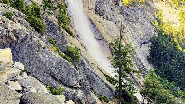 Golden sunrise light illuminates Nevada Fall and the Merced River along Yosemite's Mist Trail
