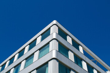 Modern corporate building facade corner under clear blue sky © Marlon