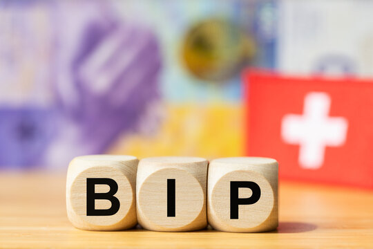 Switzerland acronym BIP, "Bruttoinlandsproduct," stands for Gross Domestic Product on wooden blocks, with a 1,000 Swiss franc banknote. Financial and business concept. Swiss financial market, 