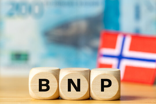 Gross Domestic Product concept in Norway with wooden blocks spelling BNP on top of Norwegian Krone banknotes. Scandinavian macroeconomic indicators. business concept. Symbol NOK
