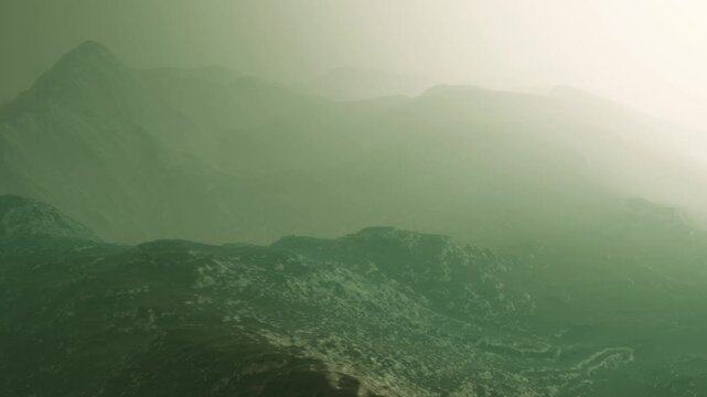 The scene shows mountains covered in fog during sunrise. The light creates a blend of soft colors. The landscape appears vast and mysterious. The view captures a natural setting and atmosphere.