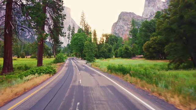 Morning light bathes the winding road as it curves through Yosemite Valley and surrounding mountains
