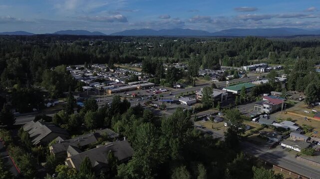 Local business districts bridge residential pockets, displaying active transit corridors through central Kent, WA. Distant mountains frame horizon, anchoring layout against wilderness backdrop