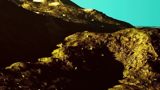 The scene shows a view of mountains with rocky surfaces. The light creates shadows on the ground. There are different colors in the landscape. It is daytime and the sky is bright.