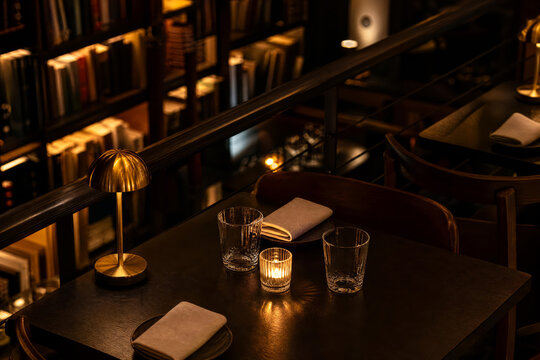 Golden Hour Candlelit Library Bistro With Charcoal Brass And Amber Tones