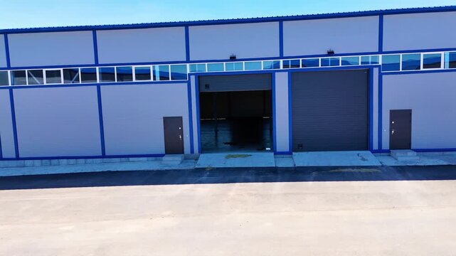 Modern Warehouse Entrance with Open Loading Door and Industrial Building Exterior