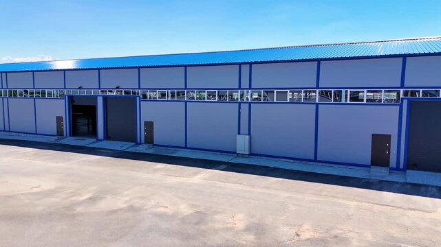 Modern Warehouse Building Exterior with Loading Doors and Industrial Facade