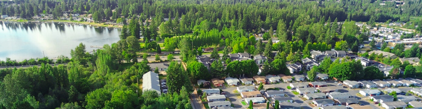 Lake Meridian in Kent enhances aesthetic appeal of quiet residential enclave while natural greenery creates vibrant thick buffer zone between individual private family homes suburbs Seattle, WA