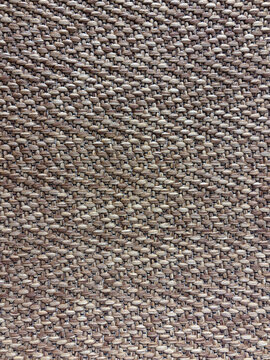 Brown and beige tightly woven upholstery textile texture with a fine repeating weave