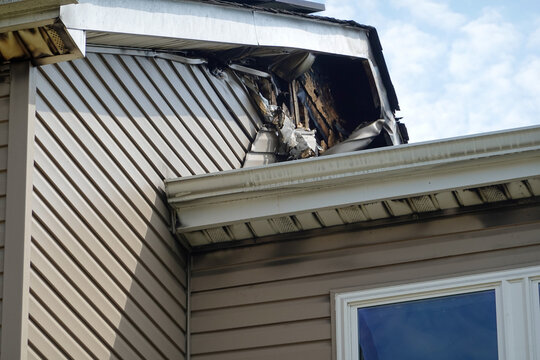 Melted vinyl siding on a house destroyed by fire