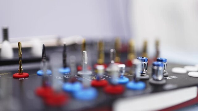 Dental surgical kit for implant placement featuring color-coded drills and precision medical instruments.