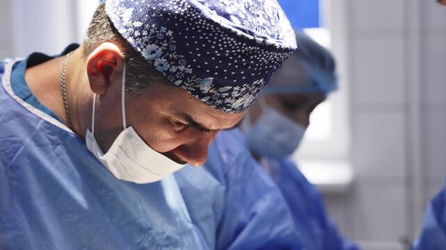 Close-up of the intense and precise work of a surgeon during an operation in a hospital operating room.