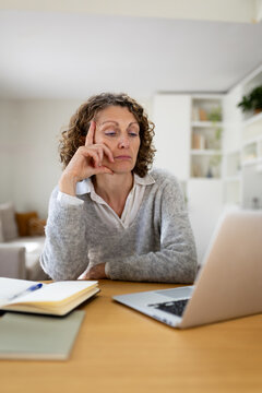 Middle-aged woman feeling bored stressed working from home