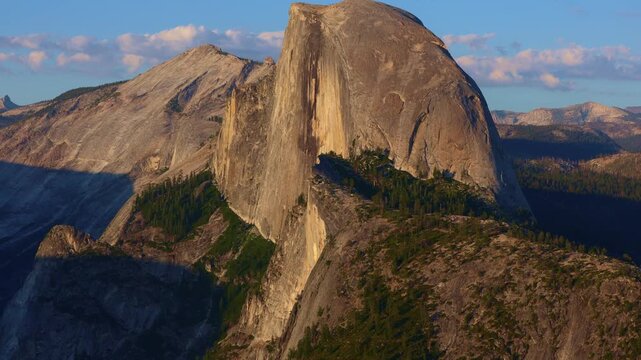 Golden sunset light bathes Half Dome as seen from Glacier Point in Yosemite
