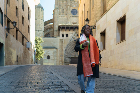 Black woman exploring historic european city street