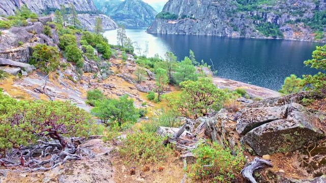 Hetch Hetchy reservoir stretches beneath the surrounding mountains in Yosemite National Park
