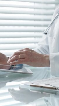 Healthcare professional wearing a lab coat and stethoscope, using a tablet and laptop, collaborating with technology for medical research, digital records, and remote patient care